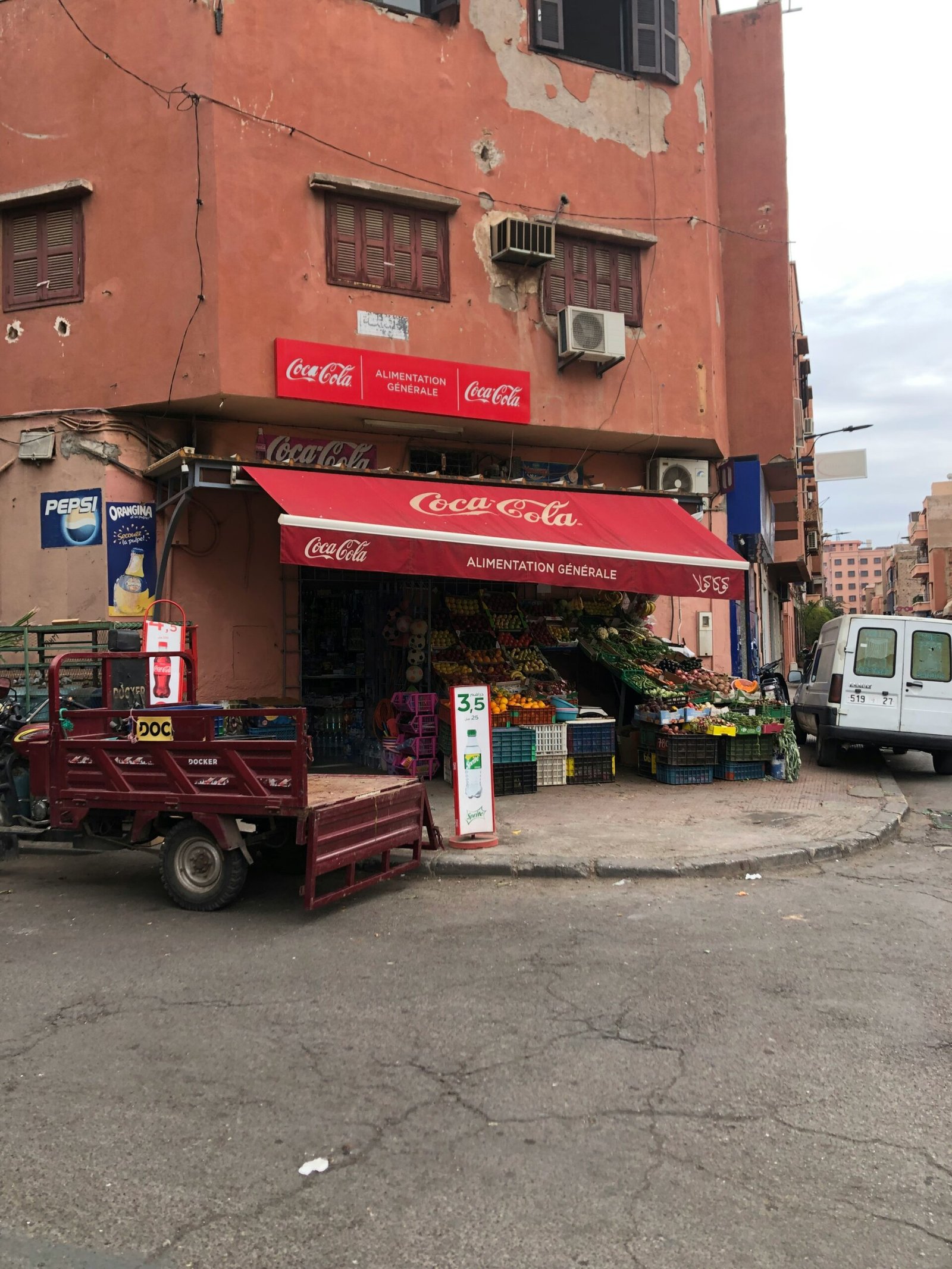 a truck parked in front of a building with a red awning